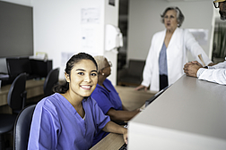 Portrait of secretary working at hospital reception