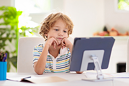 Online remote learning. School kids with computer.