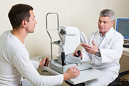 Man having his eyes examined by an eye  elderly doctor.